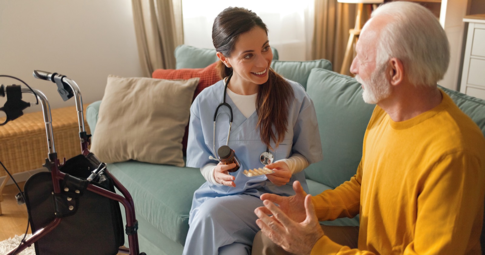 A nurse going over medication with an older man at home